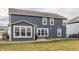View of home's backyard featuring large windows, gray siding, and patio area at 5442 W Turnbuckle Pl, McCordsville, IN 46055