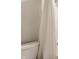 Bathroom featuring a white toilet and textured shower curtain at 5442 W Turnbuckle Pl, McCordsville, IN 46055
