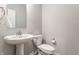 Bright half-bath with pedestal sink, white fixtures, and classic design elements at 5442 W Turnbuckle Pl, McCordsville, IN 46055
