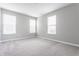 Spacious bedroom with plush carpet and three bright, sunny windows at 5442 W Turnbuckle Pl, McCordsville, IN 46055