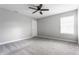 Spacious bedroom with neutral paint, carpet, ceiling fan, and a window bringing in natural light at 5442 W Turnbuckle Pl, McCordsville, IN 46055