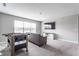 Relaxing bonus room features plush carpet, a media center, and a table game for entertainment at 5442 W Turnbuckle Pl, McCordsville, IN 46055
