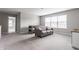 Bright bonus room features neutral decor, plush carpet, and a window that provides natural light at 5442 W Turnbuckle Pl, McCordsville, IN 46055