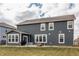 Back exterior of home featuring gray siding, a patio, and a well-maintained lawn at 5442 W Turnbuckle Pl, McCordsville, IN 46055