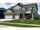 Charming two-story home featuring a manicured lawn, brick accents, and a welcoming front porch at 5442 W Turnbuckle Pl, McCordsville, IN 46055
