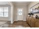 Inviting foyer with wood floors, a stylish console table, and a decorative art piece at 5442 W Turnbuckle Pl, McCordsville, IN 46055