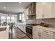 Beautiful kitchen with stainless steel range hood and gas cooktop with subway tile backsplash at 5442 W Turnbuckle Pl, McCordsville, IN 46055
