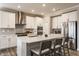 Well-appointed kitchen with quartz countertops, a stainless steel fridge, and a kitchen island at 5442 W Turnbuckle Pl, McCordsville, IN 46055