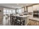 Modern kitchen featuring white cabinets, stainless steel appliances, and a large island with seating at 5442 W Turnbuckle Pl, McCordsville, IN 46055