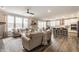 Spacious open-concept layout connecting the living room, dining area, and a modern kitchen at 5442 W Turnbuckle Pl, McCordsville, IN 46055