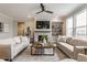 Cozy living room featuring a fireplace, comfortable seating, and a modern ceiling fan at 5442 W Turnbuckle Pl, McCordsville, IN 46055