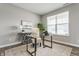 Bright office space with a glass desk, comfortable chair, and natural light from a large window at 5442 W Turnbuckle Pl, McCordsville, IN 46055