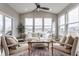 Sunroom with lots of natural light, neutral-toned seating, and view of the lake at 5442 W Turnbuckle Pl, McCordsville, IN 46055