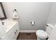 Clean and simple bathroom with white vanity and dark floors at 5450 Cody Ln, Greenwood, IN 46142