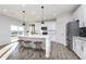 Modern kitchen with white cabinets, quartz countertops, and island at 5529 Noble Crossing W Pkwy, Noblesville, IN 46062