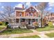 Beautiful brick home with a large porch and lush landscaping at 5730 Lawton Loop West Dr, Indianapolis, IN 46216