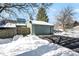 Exterior view of a light teal condo with attached garage. Snow is on the ground at 640 Blossom Dr, Avon, IN 46123