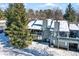 Back exterior of a two-story townhouse, snow-covered and with deck at 640 Blossom Dr, Avon, IN 46123