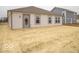 A view of the home's backyard featuring a newly constructed lawn and rear entry door at 6618 Sulgrove Pl, Indianapolis, IN 46221