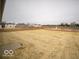Large backyard with a pond view, awaiting landscaping and personal touches at 6618 Sulgrove Pl, Indianapolis, IN 46221