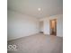 Large carpeted bedroom with neutral walls features access to an attached bathroom at 6618 Sulgrove Pl, Indianapolis, IN 46221