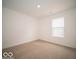 Inviting bedroom with neutral carpet, white walls, and a window showcasing the neighborhood at 6618 Sulgrove Pl, Indianapolis, IN 46221