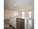 Kitchen island includes a stainless steel dishwasher and undermounted sink at 6618 Sulgrove Pl, Indianapolis, IN 46221