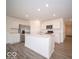 Kitchen features white cabinets, stainless steel appliances, and center island at 6618 Sulgrove Pl, Indianapolis, IN 46221