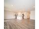 Open-concept living area with wood-look flooring and a stainless steel kitchen at 6618 Sulgrove Pl, Indianapolis, IN 46221