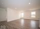 A bright living room features recessed lighting and wood-look floors at 6618 Sulgrove Pl, Indianapolis, IN 46221