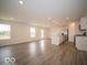 Open-concept living area with wood-look flooring and a stainless steel kitchen at 6618 Sulgrove Pl, Indianapolis, IN 46221