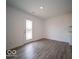 This spacious room boasts neutral walls and a glass paneled door leading to the exterior at 6618 Sulgrove Pl, Indianapolis, IN 46221