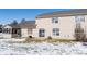 Tan, two-story house features a backyard with a screened-in porch and a patio on a partially snow-covered lawn at 7218 Forrester Ln, Indianapolis, IN 46217