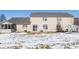 Tan, two-story house features a backyard with a screened-in porch and a patio on a partially snow-covered lawn at 7218 Forrester Ln, Indianapolis, IN 46217