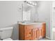 Bathroom featuring wood vanity with dual sinks and granite countertop at 7218 Forrester Ln, Indianapolis, IN 46217