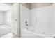 A bathtub with jets and a shower head with a view of a bright room at 7218 Forrester Ln, Indianapolis, IN 46217