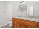 Bathroom featuring wood vanity with dual sinks and granite countertop at 7218 Forrester Ln, Indianapolis, IN 46217