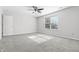 Bright bedroom features a ceiling fan and a window with natural light at 7218 Forrester Ln, Indianapolis, IN 46217