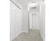 Hallway with carpet flooring, closet, and neutral walls at 7218 Forrester Ln, Indianapolis, IN 46217