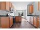 Well-equipped kitchen with sleek countertops, wooden cabinets, modern appliances and door to the yard at 7218 Forrester Ln, Indianapolis, IN 46217