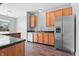 This kitchen features wooden cabinetry, stainless steel appliances, and dark countertops at 7218 Forrester Ln, Indianapolis, IN 46217