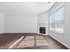 Bright living room with a fireplace, large window, and modern flooring at 7218 Forrester Ln, Indianapolis, IN 46217