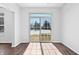Bright living room with sliding glass doors and wood-look flooring at 7218 Forrester Ln, Indianapolis, IN 46217