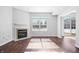 The living room features wood-look flooring, a fireplace, and a bright window at 7218 Forrester Ln, Indianapolis, IN 46217