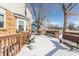 Snow-covered deck area, a great space for outdoor gatherings, surrounded by lush greenery and under a clear winter sky at 7669 Camberwood Dr, Indianapolis, IN 46268