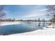 Scenic view of a partially frozen pond surrounded by snow-covered landscape and homes at 7669 Camberwood Dr, Indianapolis, IN 46268