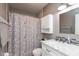 Bathroom featuring tiled shower, vanity with solid surface counter, and modern fixtures at 7775 N Kitchen Rd, Mooresville, IN 46158