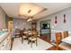 Charming dining room with hardwood floors, stylish lighting, and a view into the living area at 7775 N Kitchen Rd, Mooresville, IN 46158
