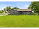 Backyard featuring well-maintained lawn and a home with modern siding and window trim at 7775 N Kitchen Rd, Mooresville, IN 46158