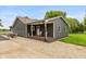 Charming gray home featuring a cozy front porch, new siding and a well-maintained yard, enhancing its curb appeal at 7775 N Kitchen Rd, Mooresville, IN 46158